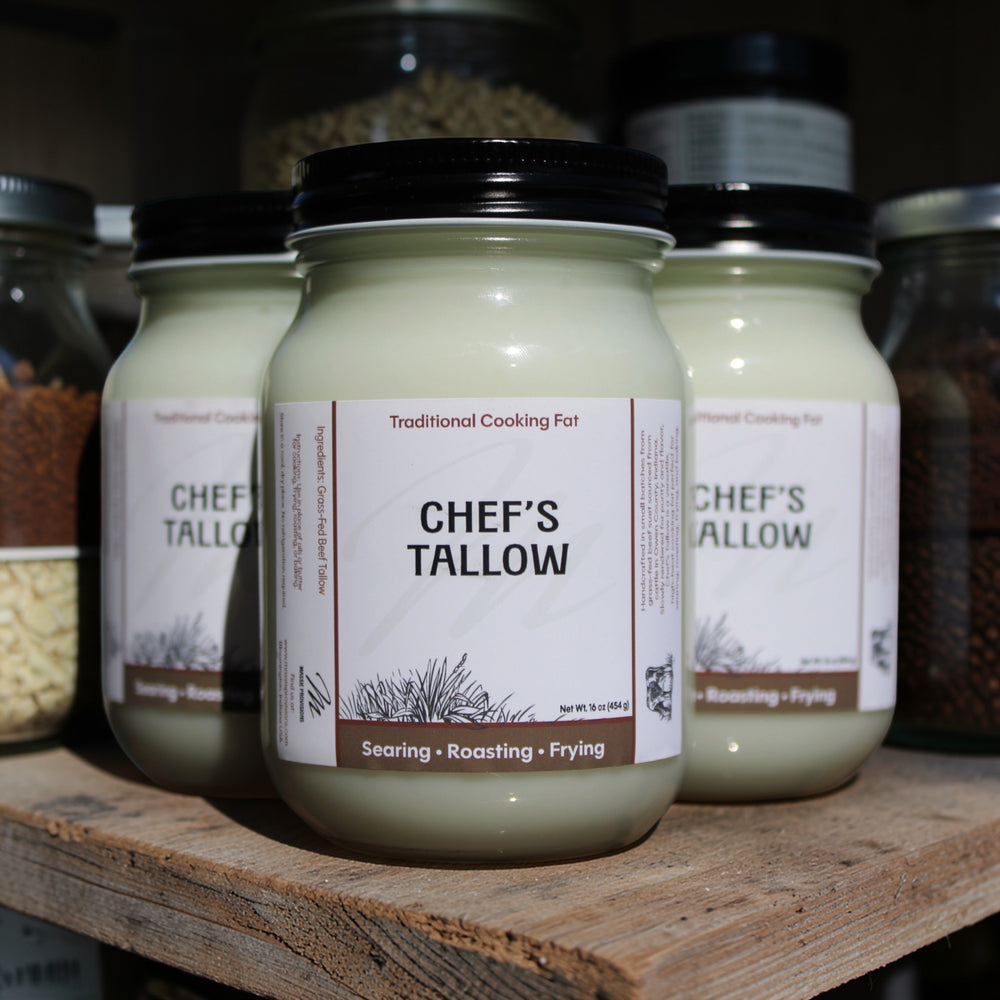 Jar of Massie Provisions Chef’s Tallow, a natural cooking fat from rendered beef fat, in a clear glass jar with a metal lid.