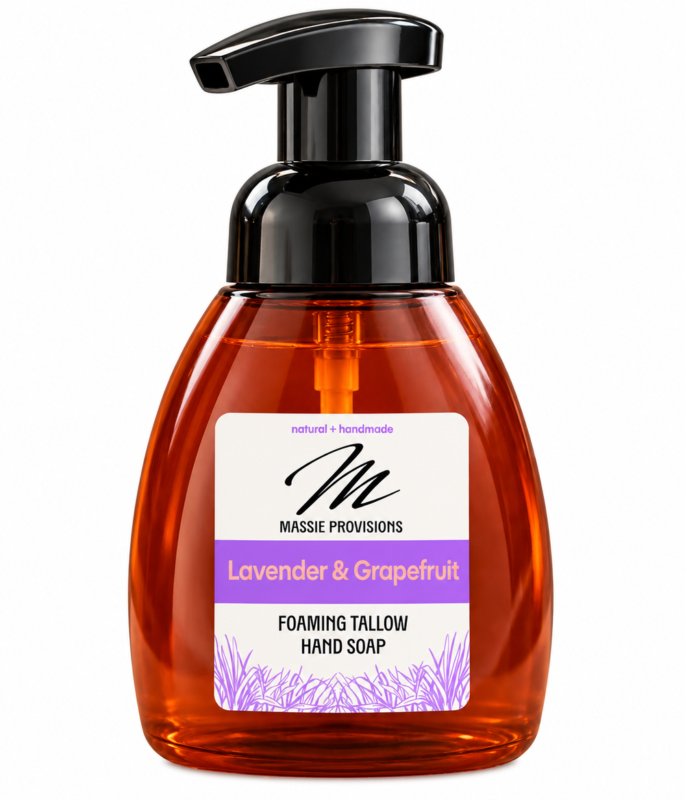 Amber lavender and grapefruit foaming soap by Massie Provisions in a clear dispenser with a pump for handwashing.